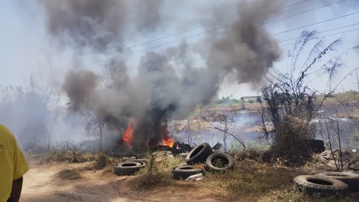 bomberos combates incendio de maleza y llantas