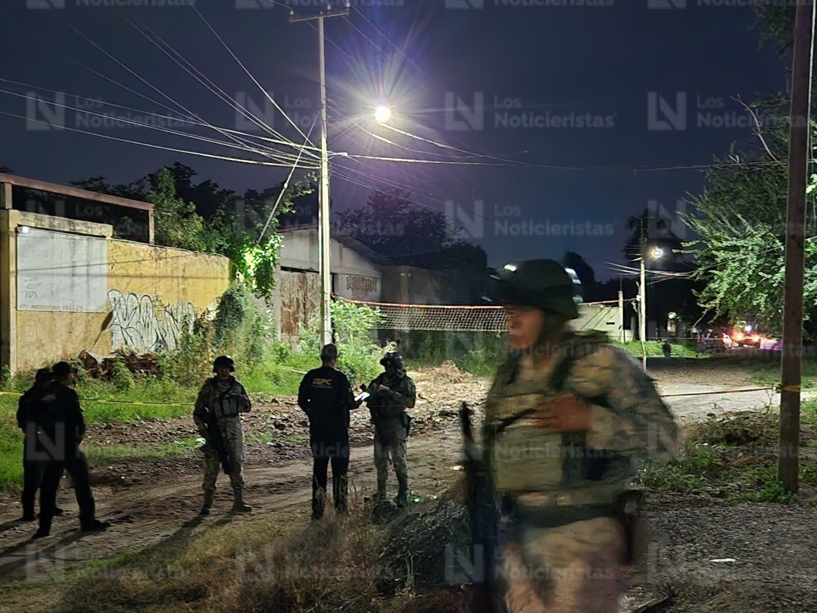 Elementos de seguridad resguardan el lugar donde un hombre fue encontrado ejecutado en Culiacán