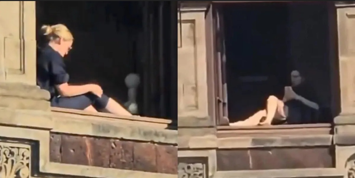Mujer tomando el sol en ventana de Palacio Nacional