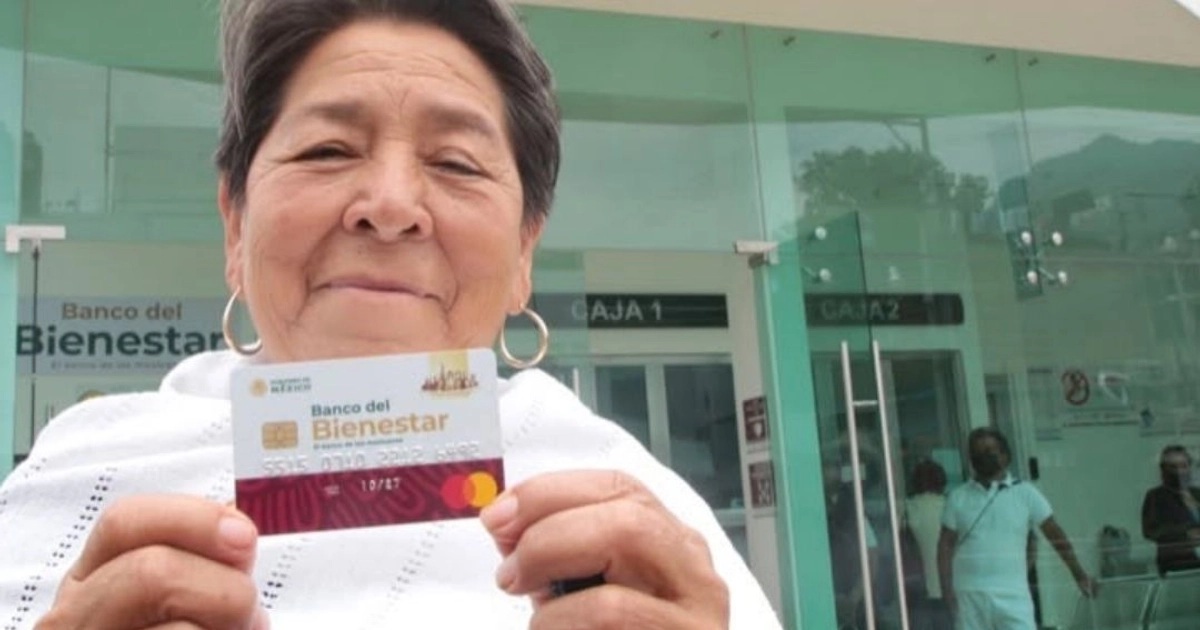 Adulta mayor con su tarjeta del Bienestar, cobrando su pensión